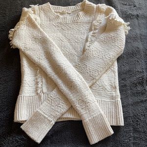 Chunky white knit sweater with frayed shoulders
